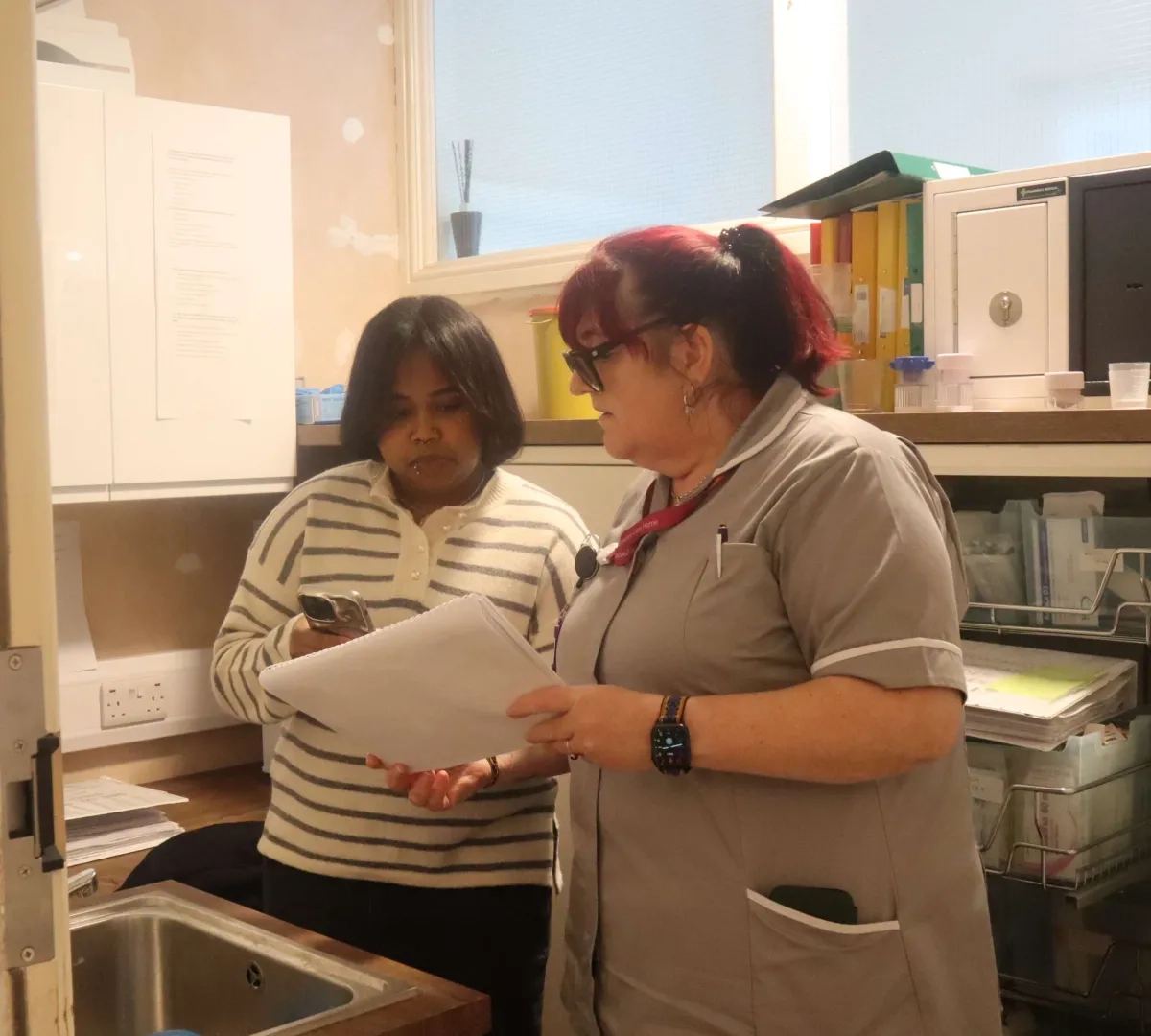 Night care assistant pictured being shadowed by a junior member of staff