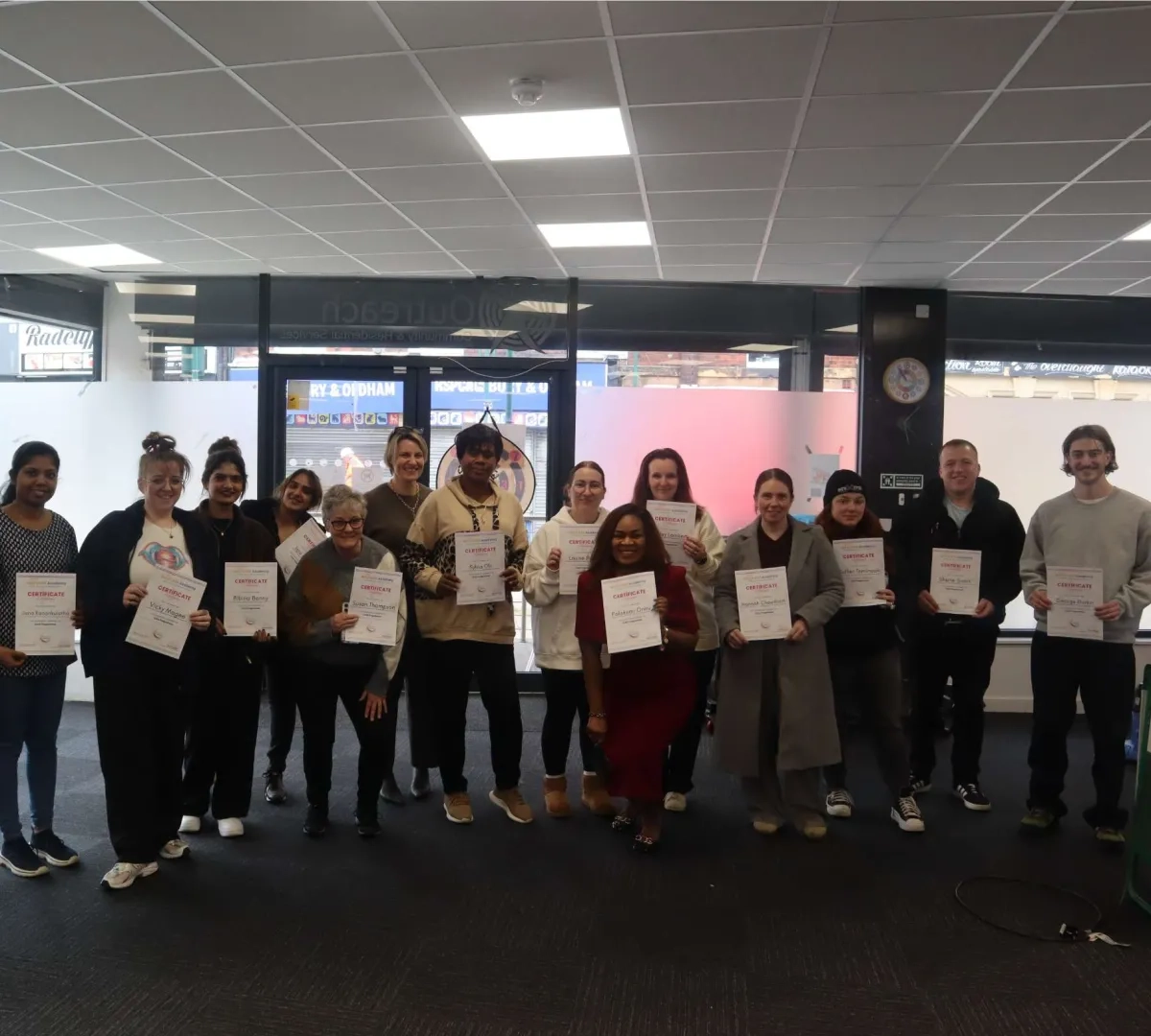 Participants of the Bury Care Academy Leadership and Development Programme pictured smiling holding up their certificates