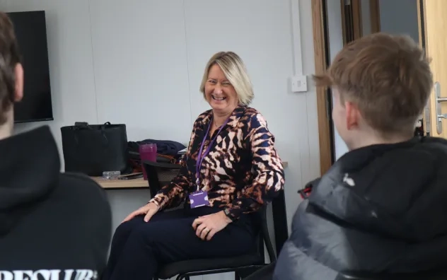Bury Care Academy manager is pictured smiling and laughing with one of the students who is smiling looking forward