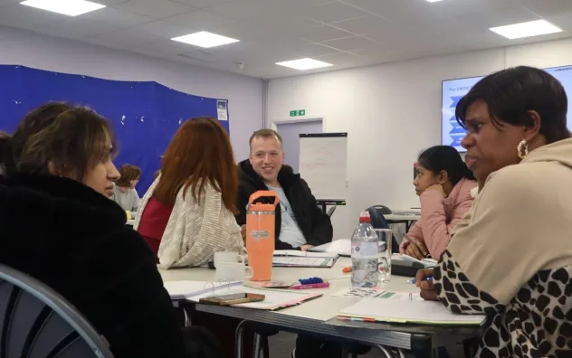 Image shows a group of participants discussing a task.