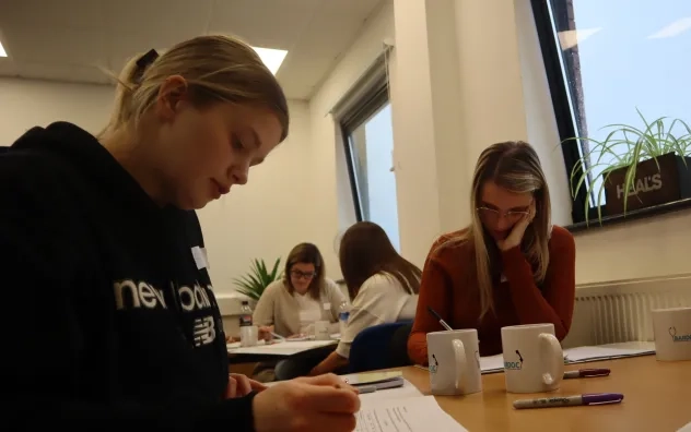 LEAD Programme attendees writing in notebooks