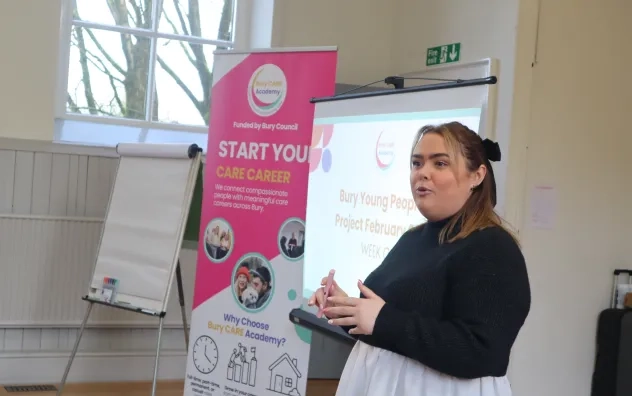 Side angle shot of Bury Care Academy trainer introducing the Young People